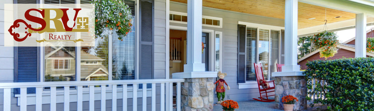 A gracious porch is invitingly decorated for autumn